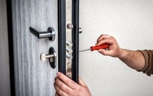 Picture of someone replacing the locks at their multi-family property.