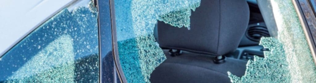 Close-up of a car with a shattered side window, highlighting property damage risks such as vandalism and theft. AI-powered forensic video investigations help property owners prevent false claims, verify incidents, and reduce liability costs with real-time monitoring and video verification.