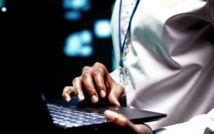 Technician configuring security system installation with live monitoring software on a laptop.