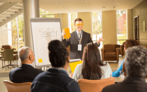 Property manager leading a safety meeting in a multifamily housing community, covering essential safety topics for residents.