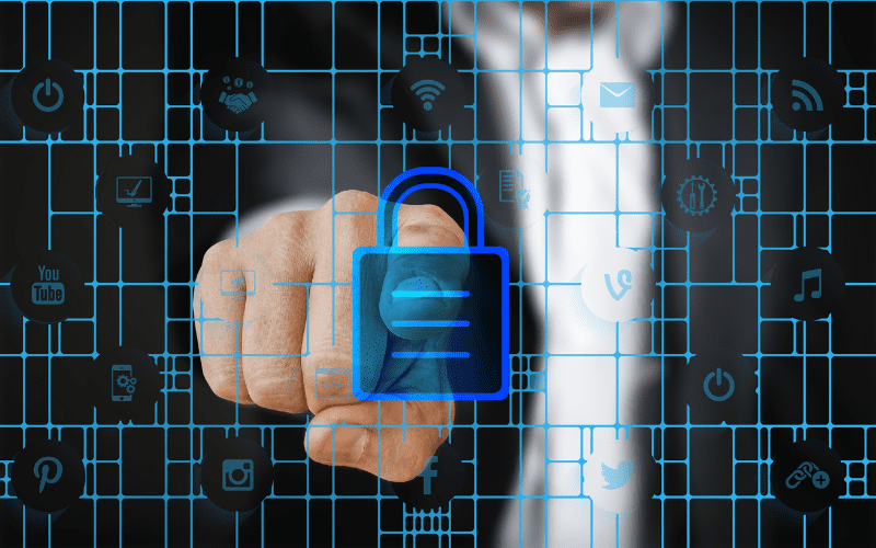 Businessman pressing a digital lock icon on a virtual touchscreen interface, symbolizing cybersecurity and data protection across connected networks.
