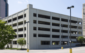 Multi-level parking garage captured in daylight with minimal vehicle presence, ideal for showcasing remote security camera monitoring capabilities in urban infrastructure settings.
