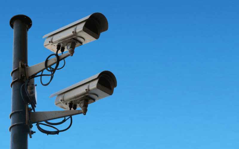 Outdoor security cameras mounted on a pole representing enterprise video surveillance systems for commercial properties