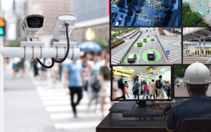 Closed-circuit television (CCTV) system monitoring urban environments, with security cameras overlooking a busy crosswalk and a surveillance operator viewing AI-analyzed footage of traffic, pedestrians, and public spaces on multiple screens.